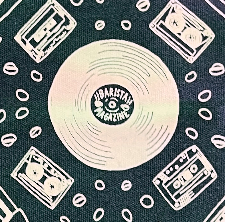 Close up of design on Barista Magazine anniversary tote featuring drawings of physical media.