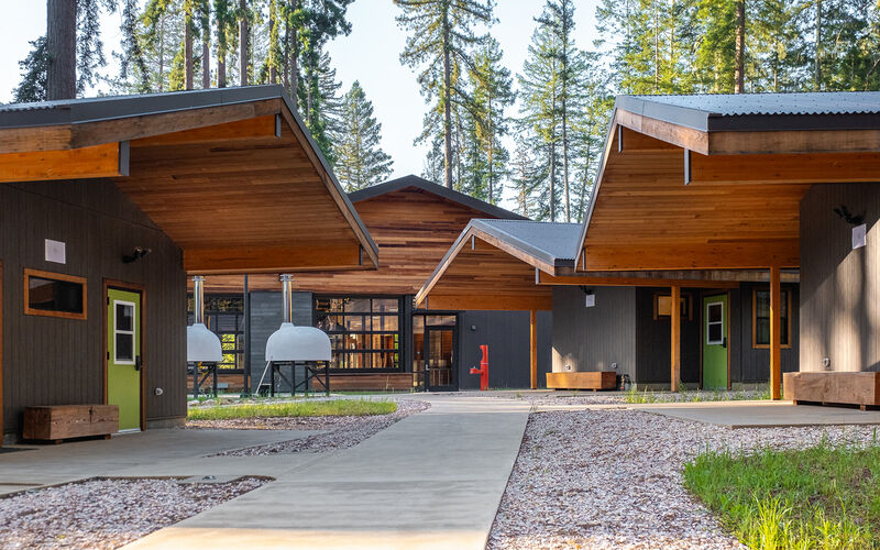 Bunkhouses with outdoor seating area in a forest setting